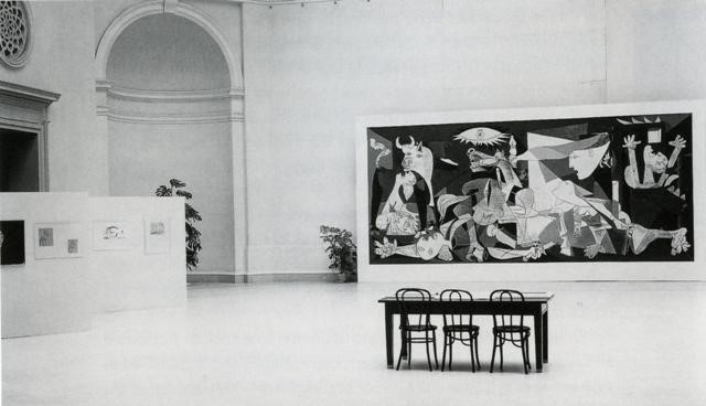 A black-and-white photograph of the painting Guernica in the original SFMOMA building