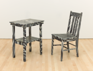 chair and table with wood grain swirls in a gallery